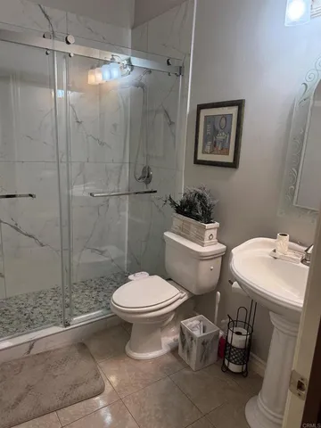 a white toilet sitting next to a bathroom sink