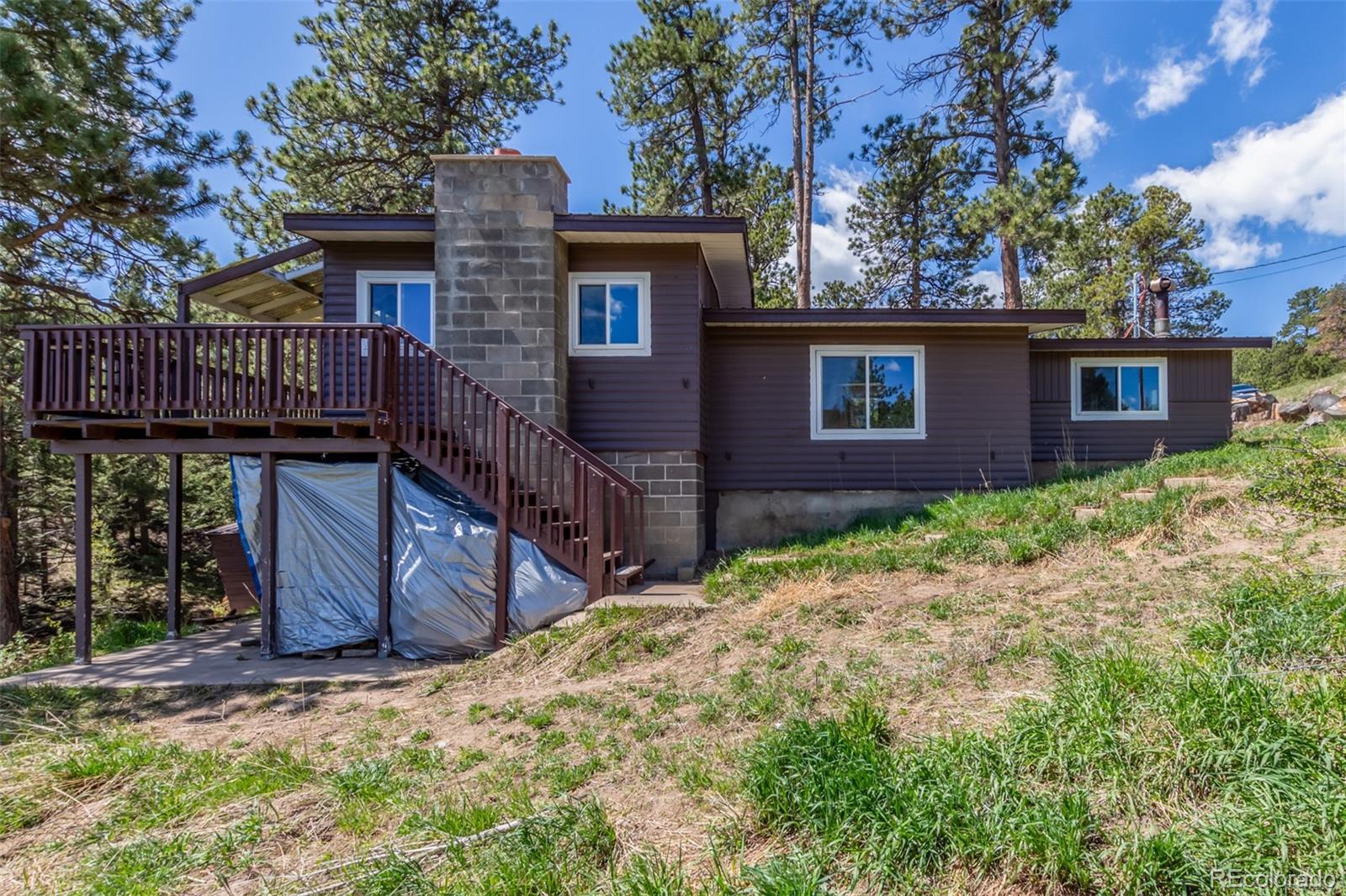 11388 Ranch Elsie Road Golden, CO 80403 - Photo 1 of 50 a view of a house with a yard and wooden fence