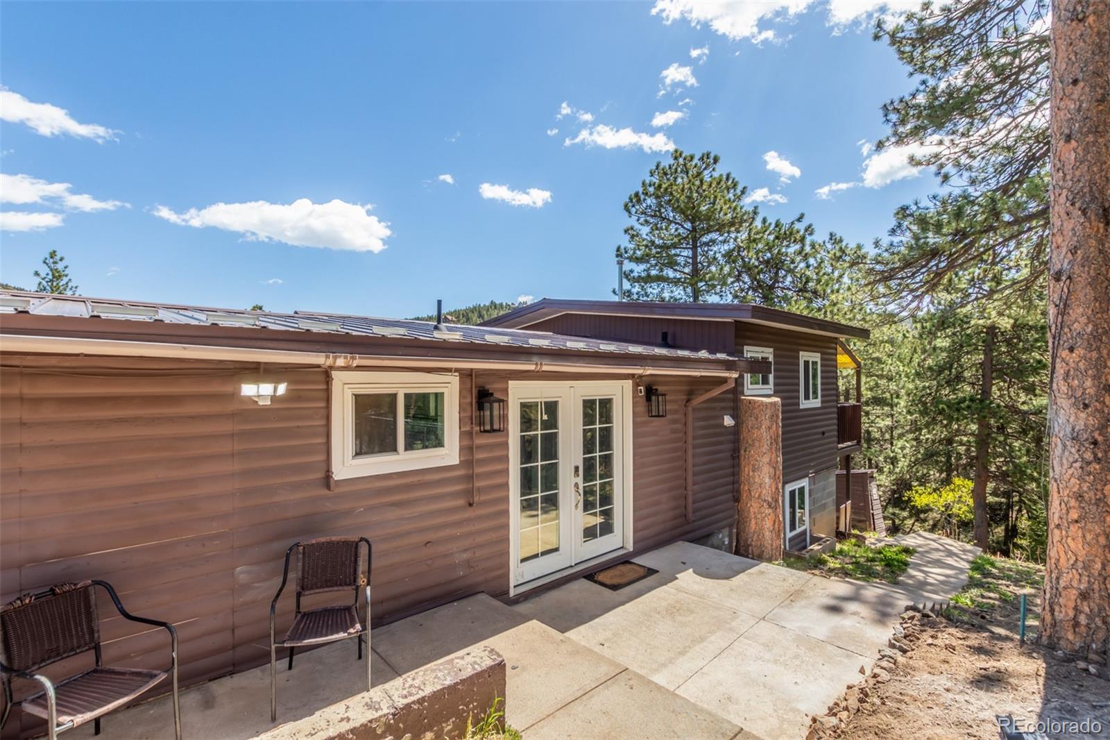 11388 Ranch Elsie Road Golden, CO 80403 - Photo 11 of 50 a backyard of a house with table and chairs