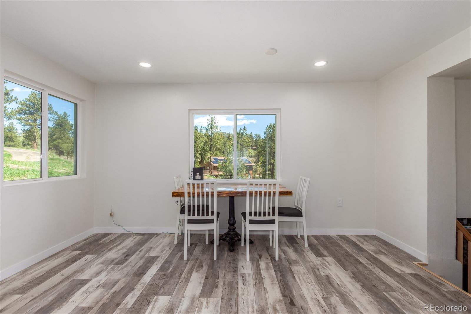 11388 Ranch Elsie Road Golden, CO 80403 - Photo 18 of 50 a workspace room with a window and wooden floor