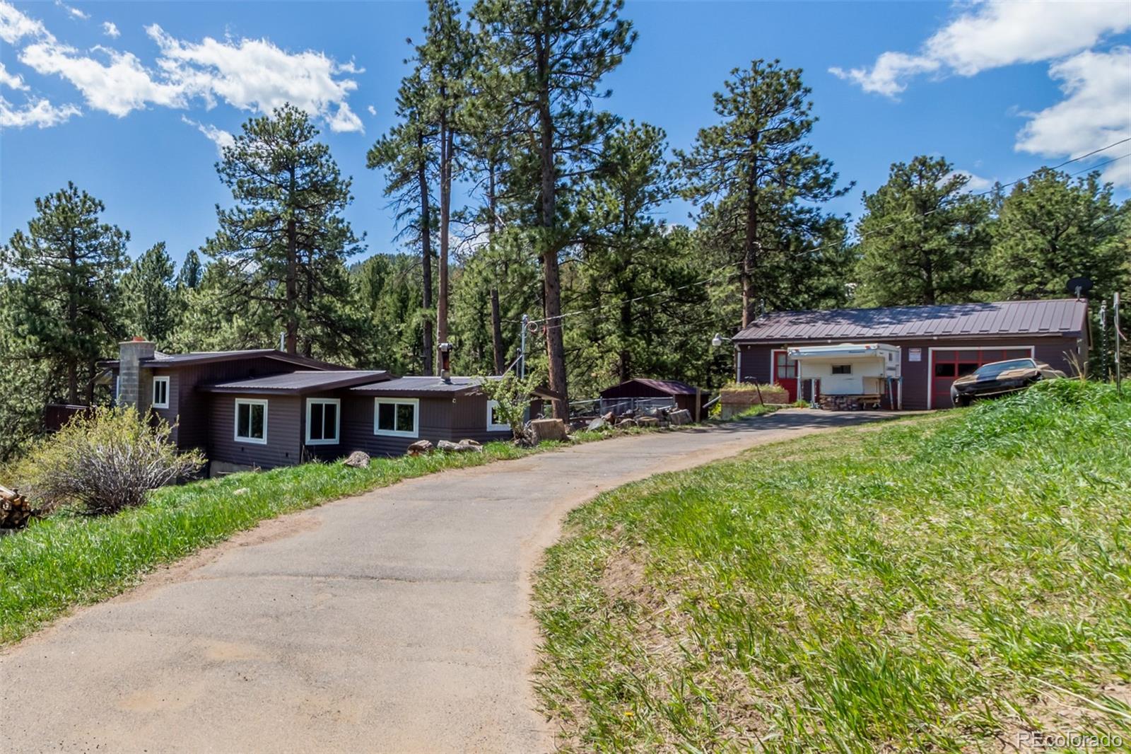 11388 Ranch Elsie Road Golden, CO 80403 - Photo 2 of 50 a front view of a house with garden