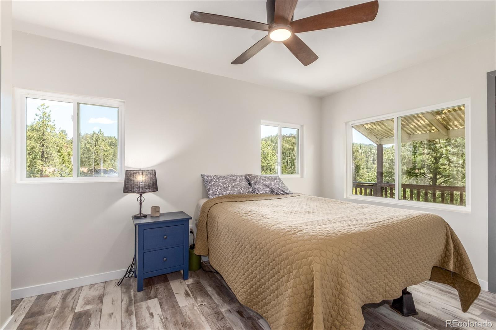 11388 Ranch Elsie Road Golden, CO 80403 - Photo 29 of 50 a bed sitting in a bedroom next to a window