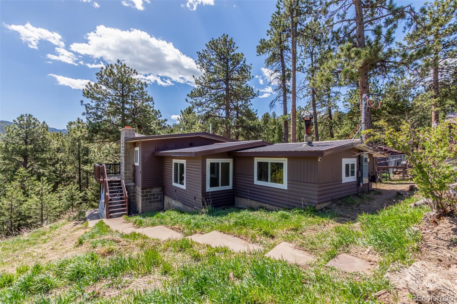 11388 Ranch Elsie Road Golden, CO 80403 - Photo 3 of 50 front view of a house with a yard