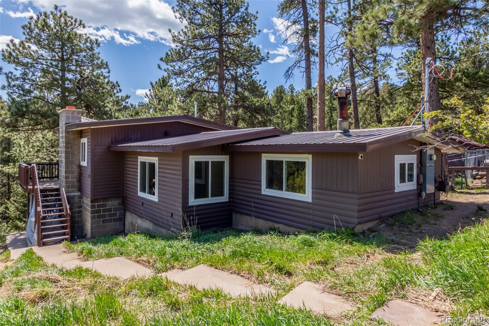 11388 Ranch Elsie Road Golden, CO 80403 - Photo 4 of 50 a view of a house with a yard