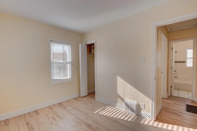 a view of wooden floor and windows in a room