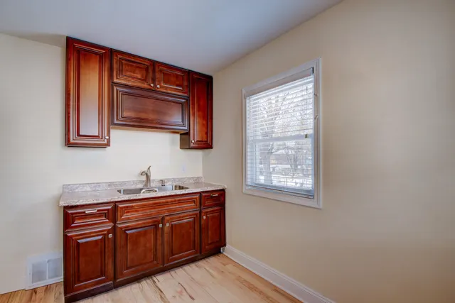 a kitchen with stainless steel appliances granite countertop wooden cabinets a sink and dishwasher