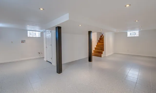 an empty room with a hallway and stairs