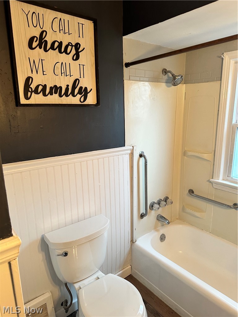 7495 Johnnycake Ridge Road Mentor, OH 44060 - Photo 20 of 50 Bathroom with toilet, wood-type flooring, and tiled shower / bath