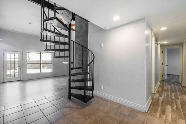 a view of entryway with stairs and wooden floor