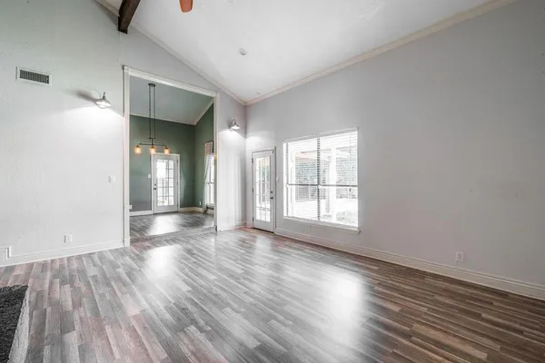 wooden floor in an empty room with a window