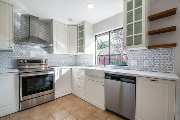 a kitchen with stainless steel appliances granite countertop a sink and a microwave