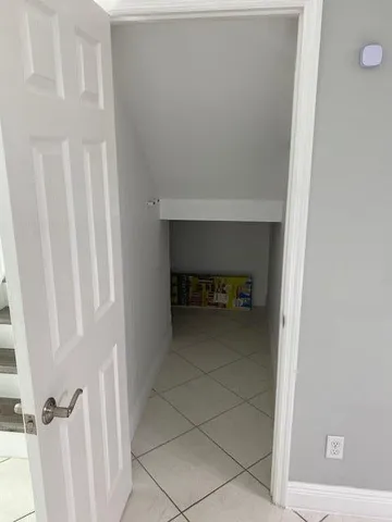 a view of kitchen with microwave and cabinets