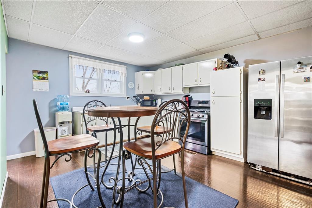 90 Dellenbaugh Road Tarentum, PA 15084 - Photo 7 of 25 a kitchen with stainless steel appliances a table chairs and a refrigerator