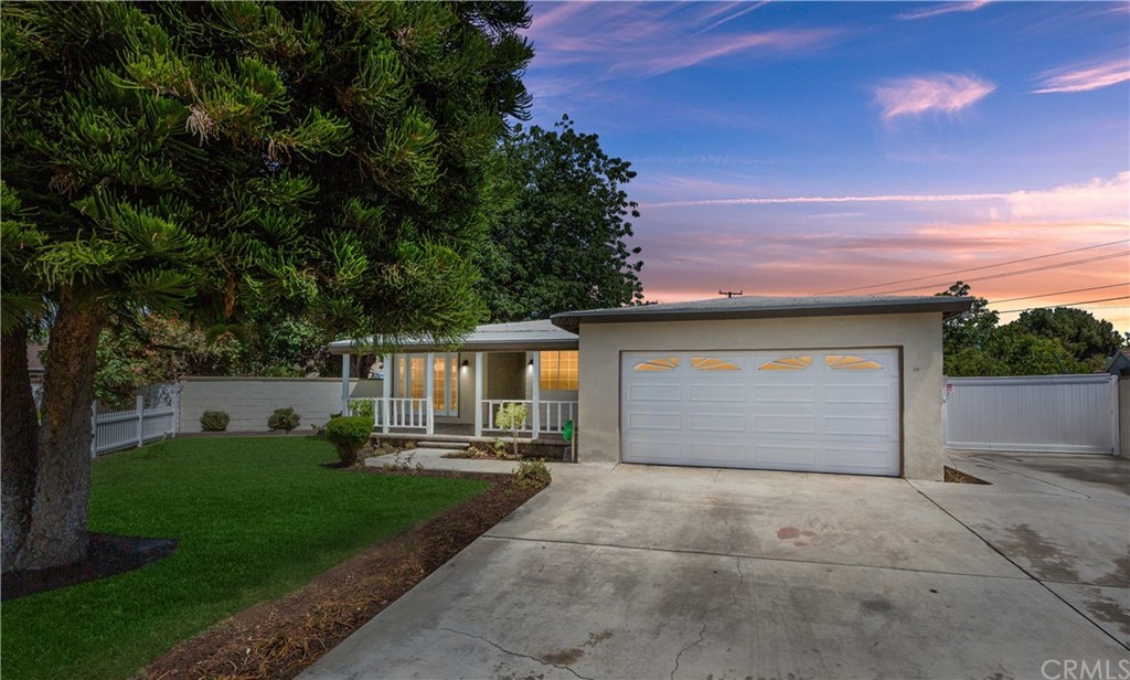 10039 Judy Court Riverside, CA 92503 - Photo 1 of 1 a front view of a house with a yard and garage