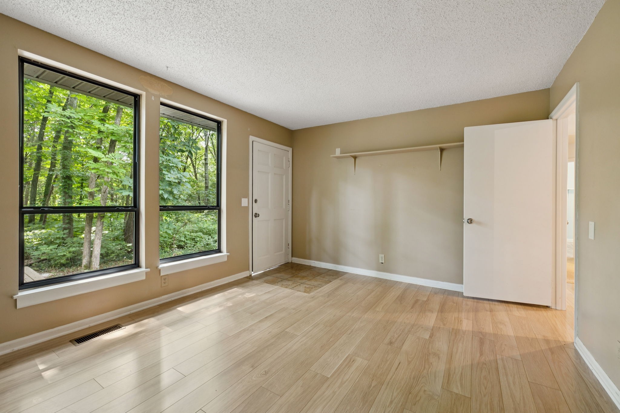 6031 Buckeye Valley Road Murfreesboro, TN 37129 - Photo 14 of 47 a view of an empty room with wooden floor and a window