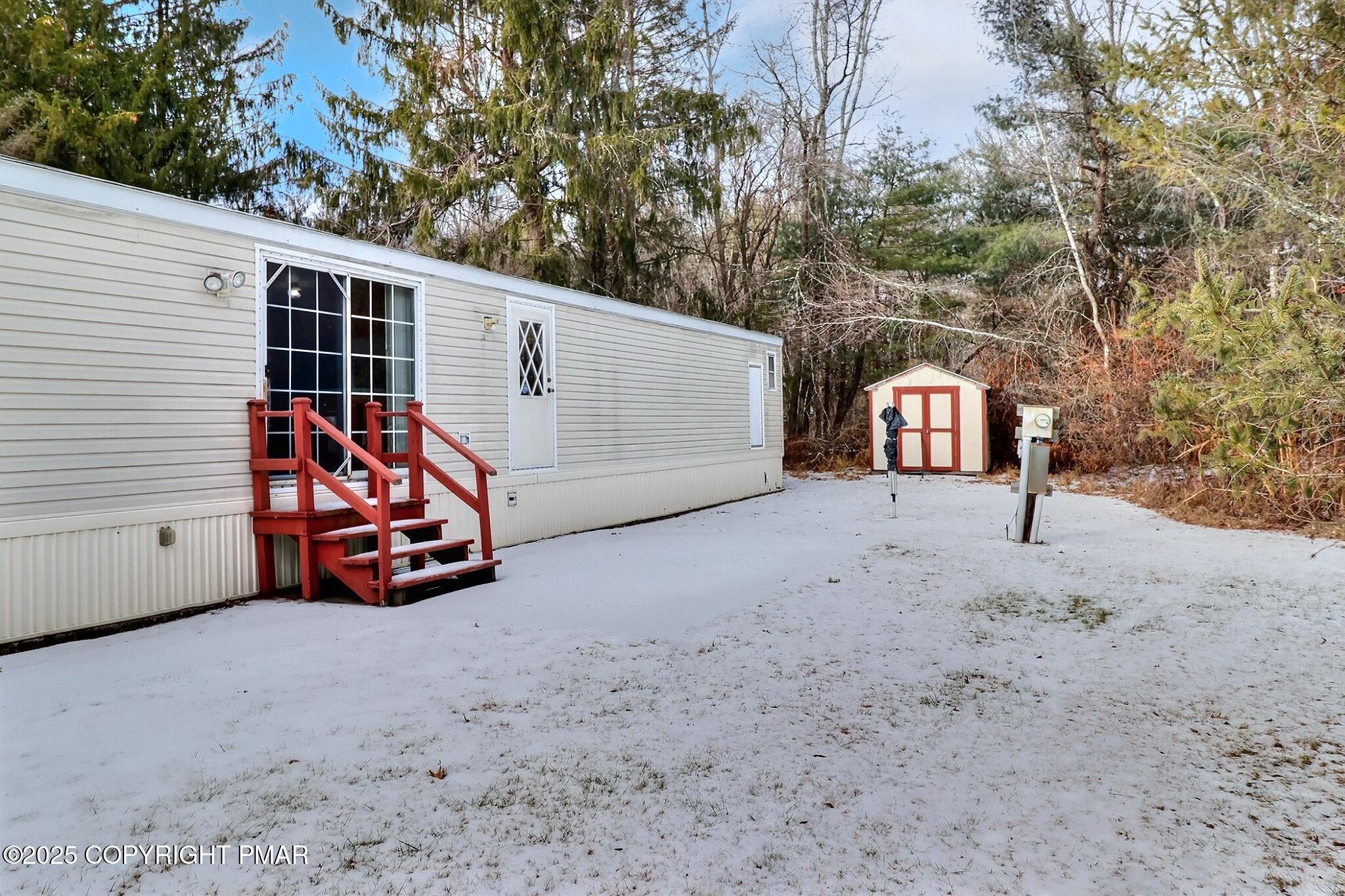 205 Oak Run Lane Stroudsburg, PA 18360 - Photo 5 of 29 a view of a house with large trees and covered with snow in front of house