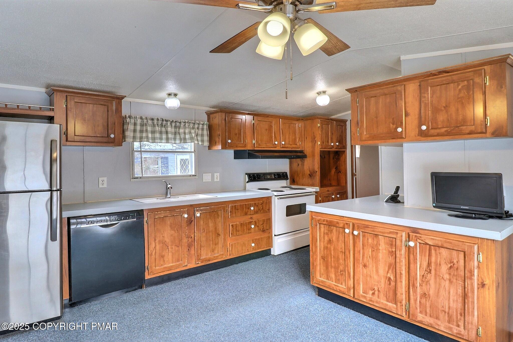 205 Oak Run Lane Stroudsburg, PA 18360 - Photo 8 of 29 a kitchen with stainless steel appliances kitchen island granite countertop a stove top oven a sink a counter space and cabinets