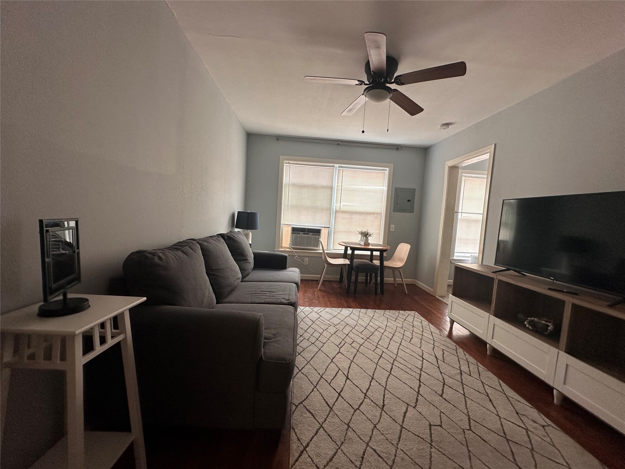 4302 Polk Street, Unit 8 Houston, TX 77023 - Photo 1 of 9 a living room with furniture and a flat screen tv