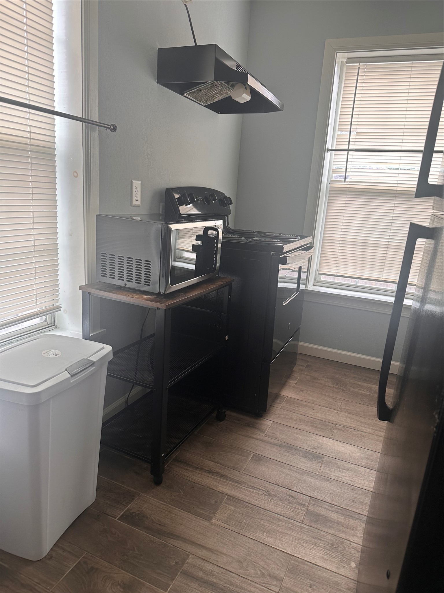 4302 Polk Street, Unit 8 Houston, TX 77023 - Photo 5 of 9 a kitchen with stainless steel appliances granite countertop a sink a stove and a wooden floors