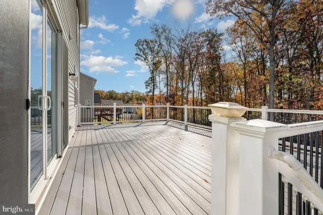 a view of a balcony with wooden floor and fence