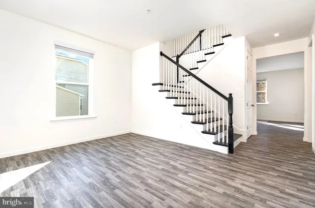 a view of a room with wooden floor and staircase