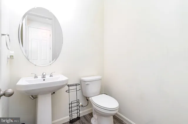 a bathroom with a sink toilet and a mirror