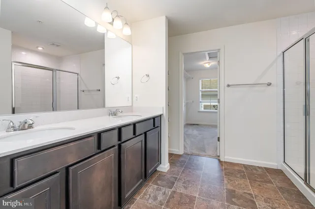 a bathroom with a double vanity sink and a mirror