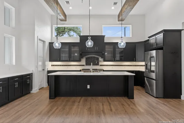 a kitchen with stainless steel appliances granite countertop a refrigerator and a stove