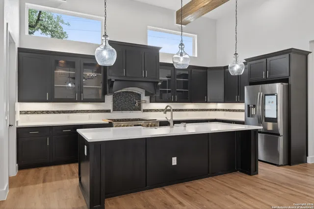 a kitchen with stainless steel appliances a sink and a refrigerator