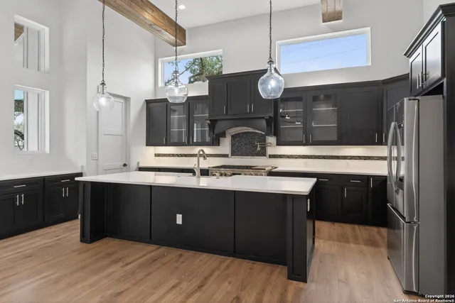 a kitchen with a sink cabinets and stainless steel appliances