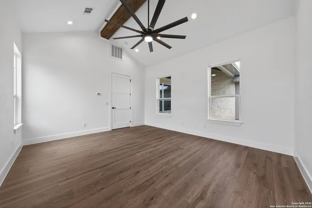 wooden floor in an empty room with a window