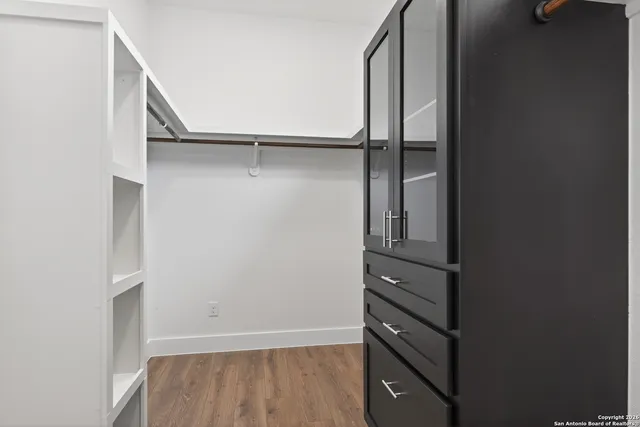 a view of walk in closet with empty racks