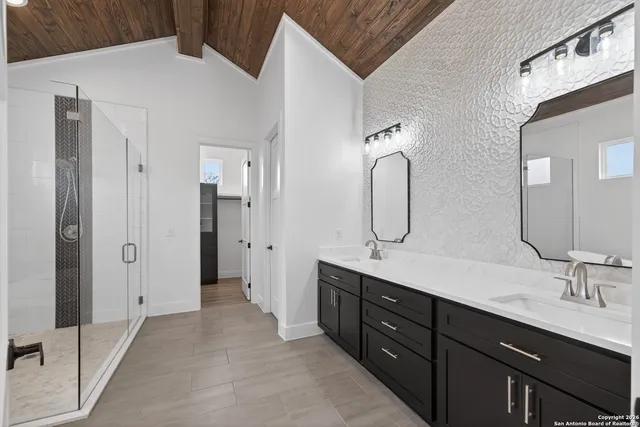 a spacious bathroom with a double vanity sink double and mirror