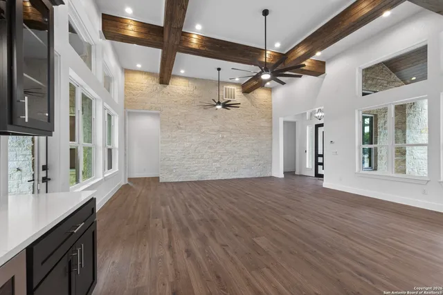 a view of a hallway with wooden floor and entryway