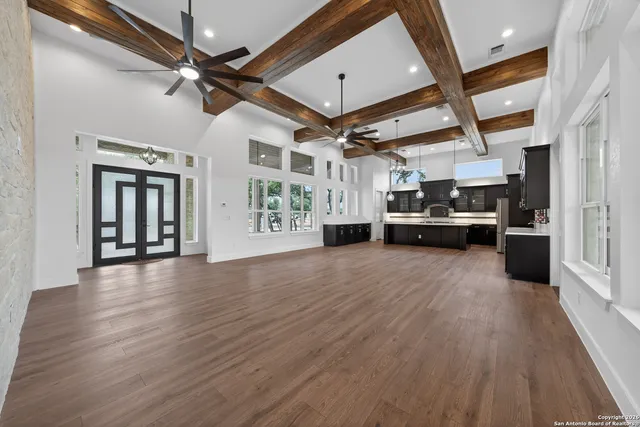 a view of a livingroom with hardwood floor and a ceiling fan