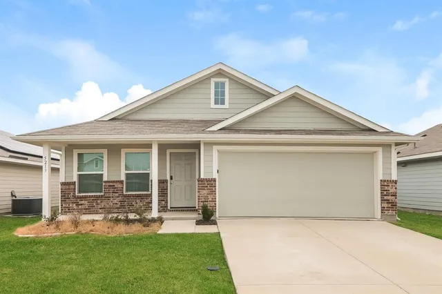a front view of a house with a yard and porch