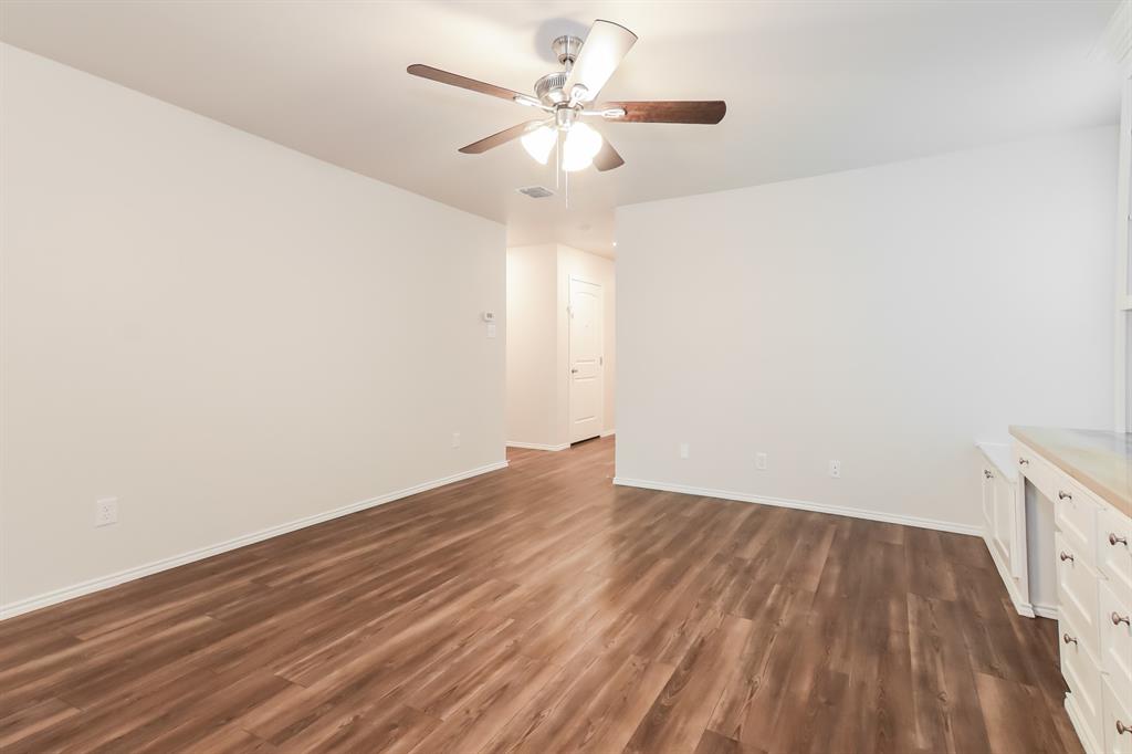 5213 Longshadow Drive Princeton, TX 75407 - Photo 3 of 16 a view of a room with wooden floor and a ceiling fan
