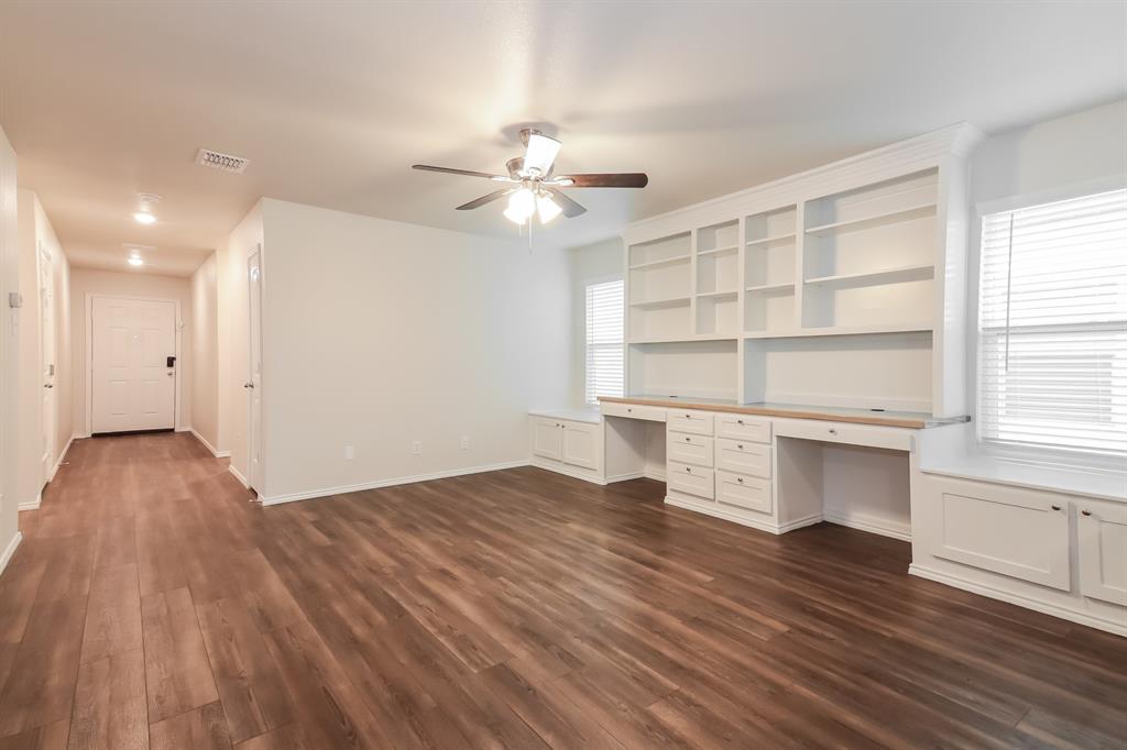 5213 Longshadow Drive Princeton, TX 75407 - Photo 4 of 16 a view of an empty room with a window and wooden floor