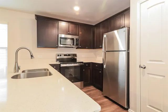 a kitchen with a refrigerator sink and microwave