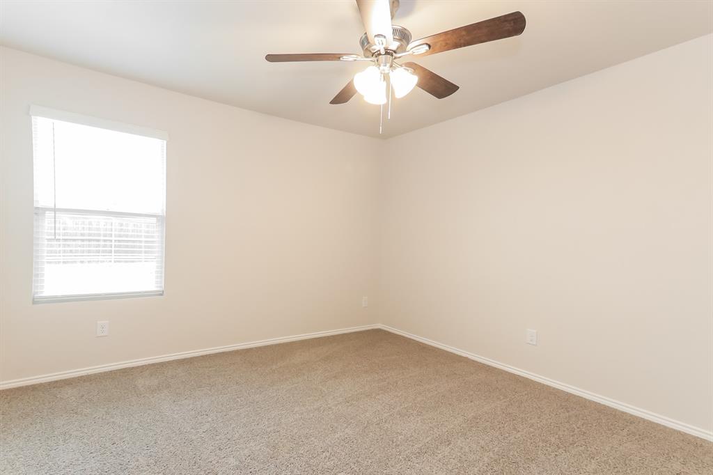 5213 Longshadow Drive Princeton, TX 75407 - Photo 9 of 16 an empty room with a window and a fan