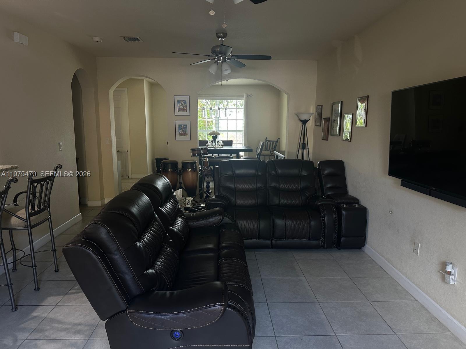 17135 Southwest 96th Street Miami, FL 33196 - Photo 22 of 36 a living room with furniture and a flat screen tv