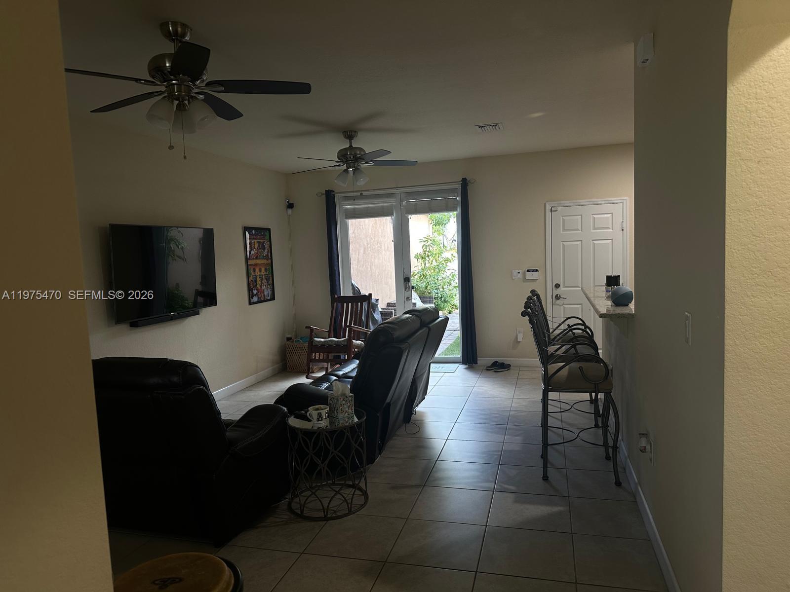 17135 Southwest 96th Street Miami, FL 33196 - Photo 23 of 36 a living room with furniture and a flat screen tv