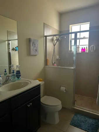 a bathroom with a toilet a sink and shower