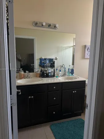 a bathroom with a sink vanity and mirror