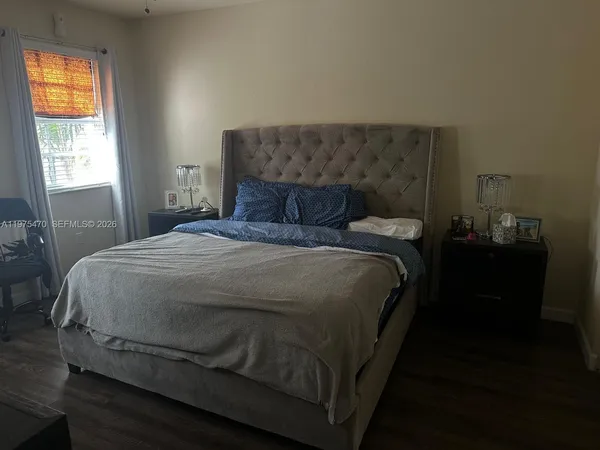 a bed sitting in a bedroom next to a window