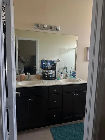 a bathroom with a sink vanity and mirror