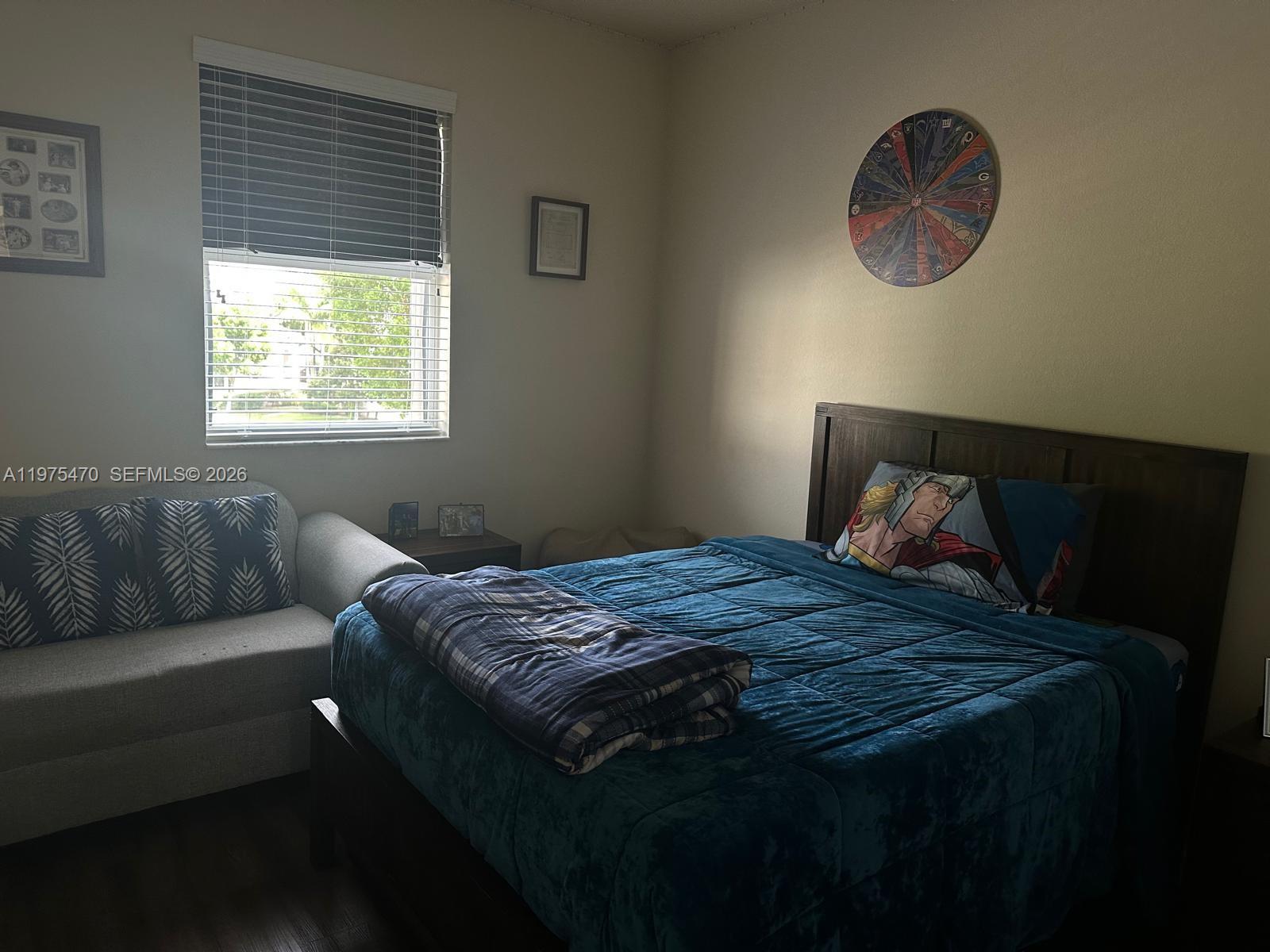 17135 Southwest 96th Street Miami, FL 33196 - Photo 6 of 36 a bed sitting in a bedroom next to a window