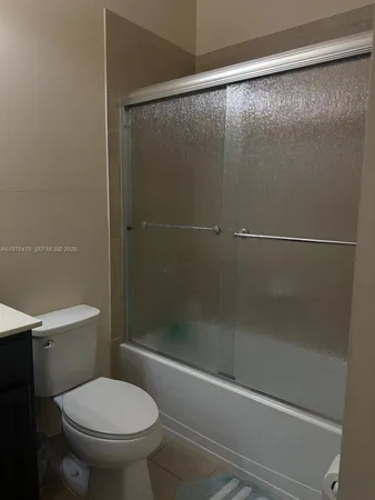 a bathroom with a shower and a toilet