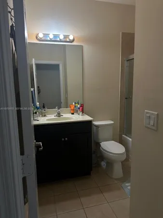 a bathroom with a sink vanity and a toilet