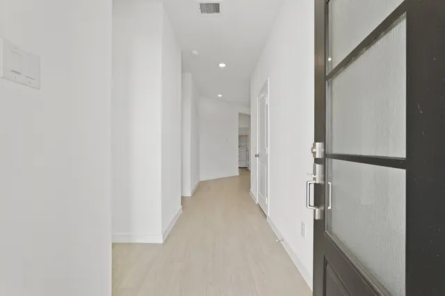 a view of a hallway with a white walls